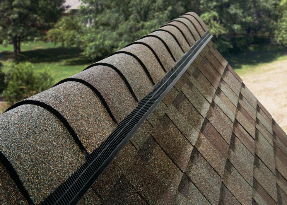 Close-up of ridge cap shingles and a ridge vent on an asphalt shingle roof