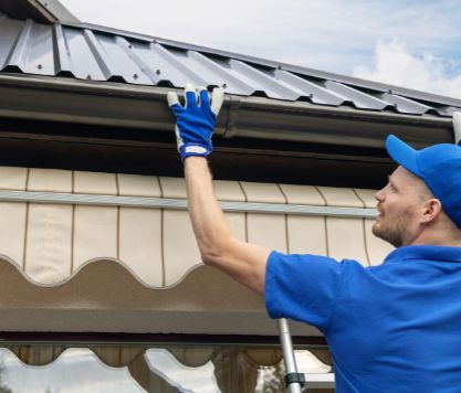 metal-roof-repair-central-fl SunVena Roofing contractor repairing metal seam on tin roof in Orlando, FL