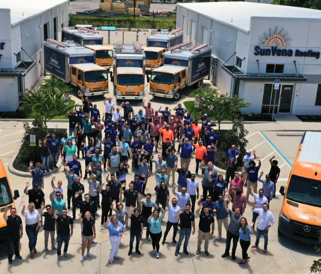 Aerial view of the SunVena team outside the company building with its fleet of trucks and vans